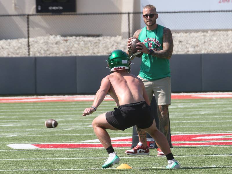 L-P head football coach JJ Raffelson, throws passes to players during the first day of football practice on Monday, Aug. 11, 2025 at Howard Fellows Stadium.