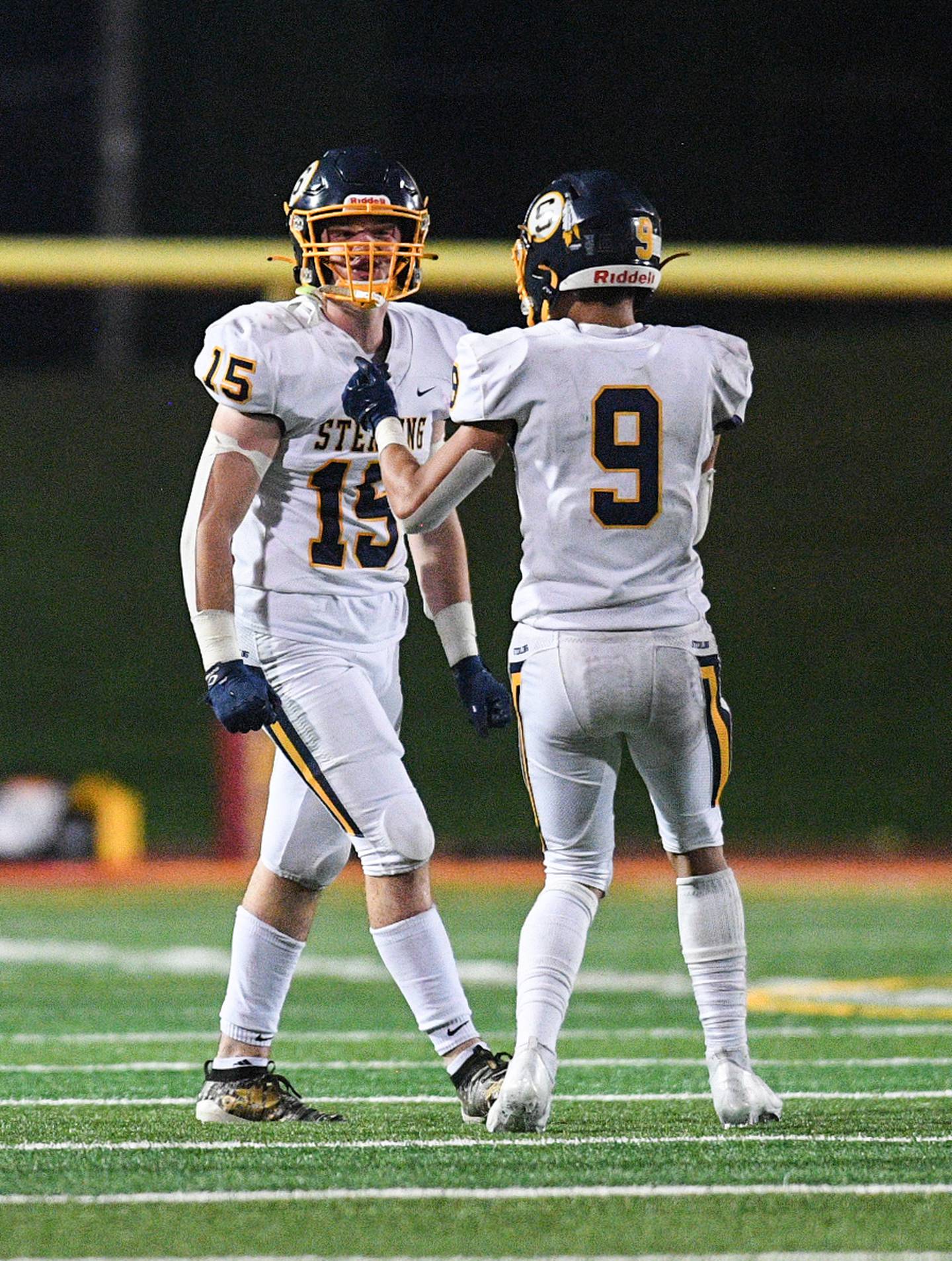 Sterling's Carter Ryan (15) and AJ Kested (9) celebrate during their game against Rock Island at Almquist Field Friday, Oct. 8, 2021, in Rock Island.