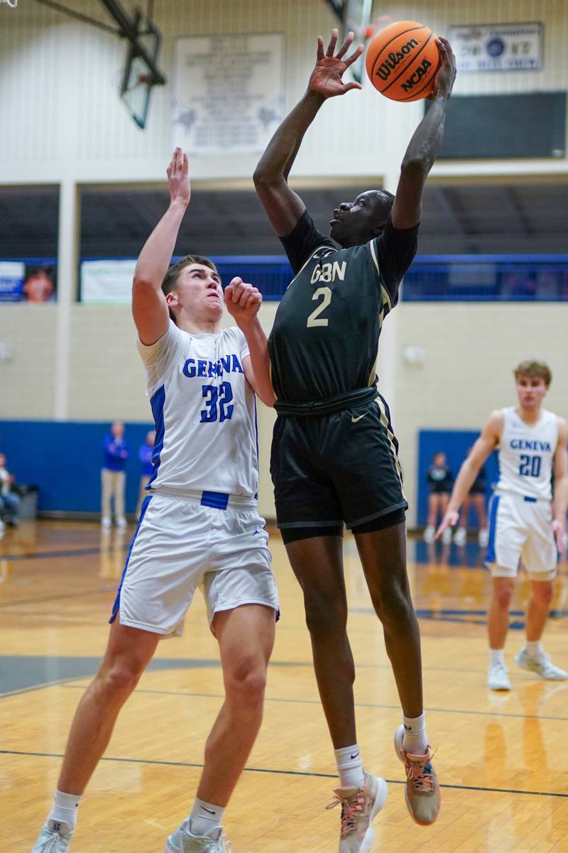 Glenbard North's Oturo Redento (2) shoots the ball in the paint over Geneva’s Benjamin Peterson (32) during a class 4A Geneva Regional final basketball game at Geneva High School on Friday, Feb. 28, 2025.