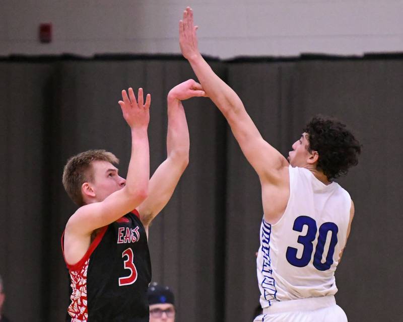 Glenbard East's Danny Snyder (3) makes a three-point basket while Riverside-Brookfield's Liam Enright (30) tries to block the shot during the game on Tuesday Feb. 3, 2026, held at Riverside-Brookfield High School.