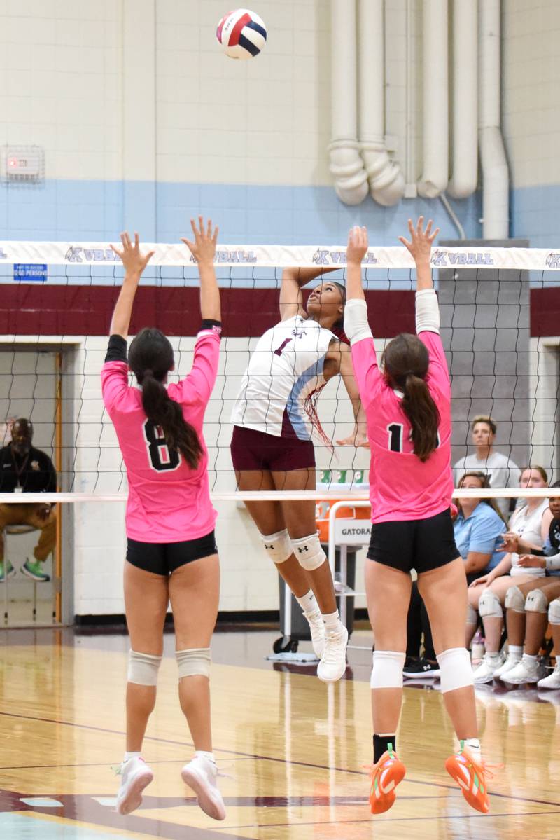Kankakee's Ki'Asia Wilson, center, times her kill attempt as Bradley-Bourbonnais' Hannah Wojnowski, left, and Ella Haas time their block during All-City action at Kankakee Tuesday, Sept. 9, 2025.