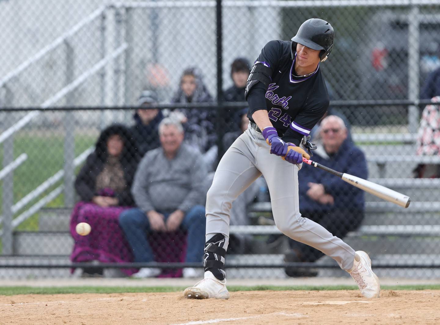 Downers Grove North's George Wolkow (24) swings at a pitch during the varsity baseball game between Downers Grove South and Downers Grove North in Downers Grove on Saturday, April 29, 2023.