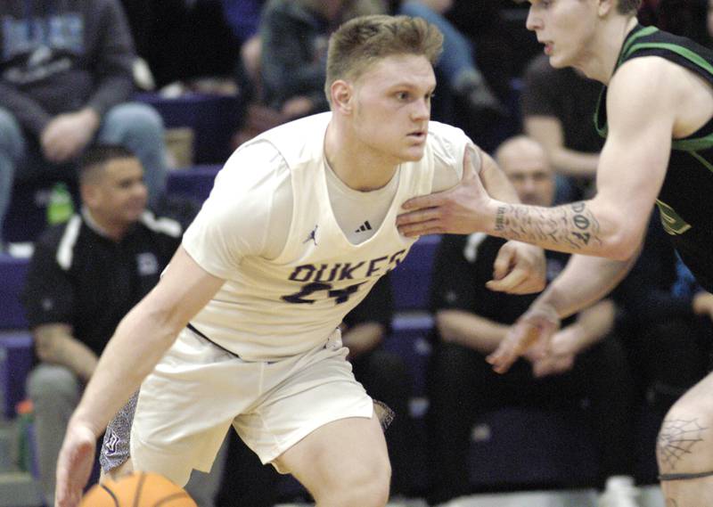 Dukes player Eli Davidson drives against a Rock Falls defender. Dixon hosted Rock Falls in boys basketball Friday, February 14, 2025 at Lancaster Gym at Dixon High School. Rock Falls won a hard fought game 48-46.