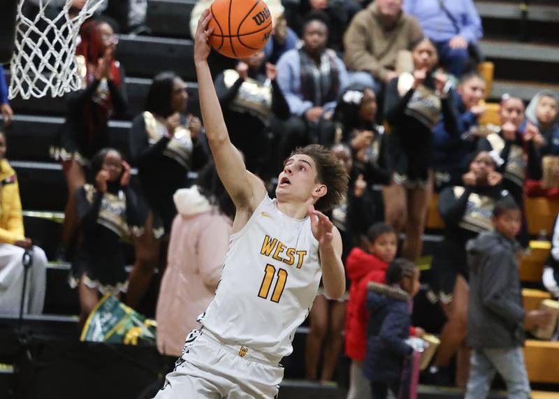Joliet West’s Luke Grevengoed lays in a shot against Joliet Central on Tuesday, Dec. 3, 2024 in Joliet.