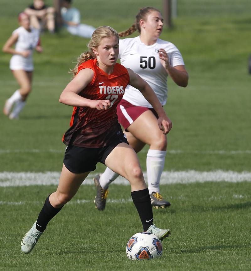 Crystal Lake Central's Olivia Anderson push the ball up the field against Prairie Ridge's Grace Wolf during a Fox Valley Conference soccer match Tuesday, May 10, 2022, between Crystal Lake Central and Prairie Ridge at Crystal Lake Central High School. Anderson scored a goal on the play.