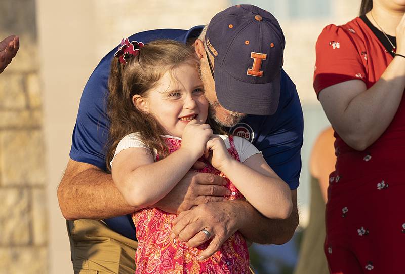 Grandpa Dennis Rockwell hugs Ella Hollowell after the duo was given third place Thursday, Aug. 9, 2024 in the finals of Rock Falls Tourism’s Sauk Valley Talent Competition.