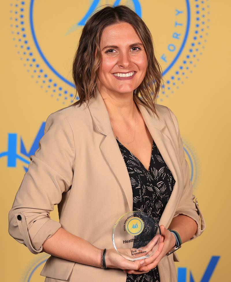 Heather Seghi poses with her 40 Under Forty award during the Illinois Valley Chamber of Commerce Champions of Change Awards Night on Thursday, April 10, 2025 at the Westclox Event Center in Peru.