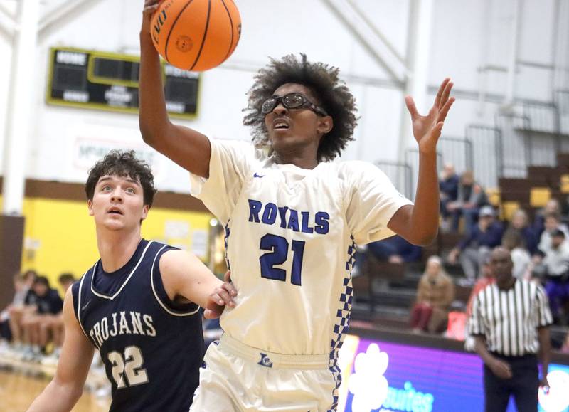 Larkin’s Mac Irvin, right, gathers a rebound in front of Cary-Grove’s Adam Bauer in varsity boys basketball Hinkle Holiday Classic action on Friday, Dec. 26, 2025, at Jacobs High School in Algonquin.