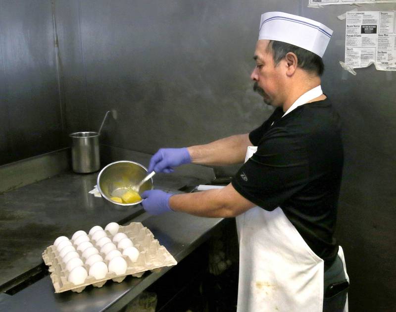 Billy Jasso, a line cook at Sycamore Parkway Restaurant, scrambles some eggs Friday, Feb. 21, 2025, at the eatery in Sycamore.