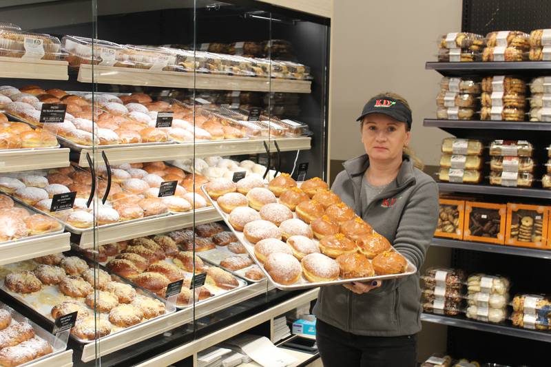 KD Market Bakery Manager Edyta Pacek holds a tray of freshly made paczkis on Feb. 26, 2025 at the Crystal Lake store.