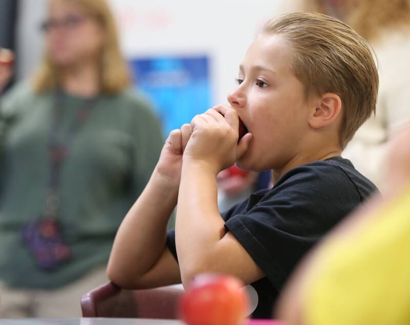 Eric Robbins a student at Northwest Elementary School, bites into a apple during the Great Apple Crunch on Thursday, Oct,. 12, 2023 at Northwest School in La Salle. The Great Apple Crunch is an annual celebration of fresh, local apples on the second Thursday of October during National Farm to School Month. The apples were donated by Boggios Orchard and Produce.
