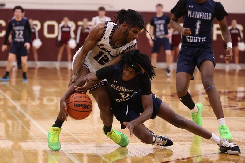Plainfield South’s Michael Smith II beats Lockport ’s Jalen Falcon to the loose ball on Wednesday January 25th, 2023.