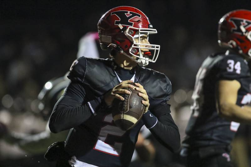 Yorkville's Jack Beetham (2) rolls out during Class 7A first round football game between Glenbard North at Yorkville. Friday, Oct 31, 2025 in Yorkville.