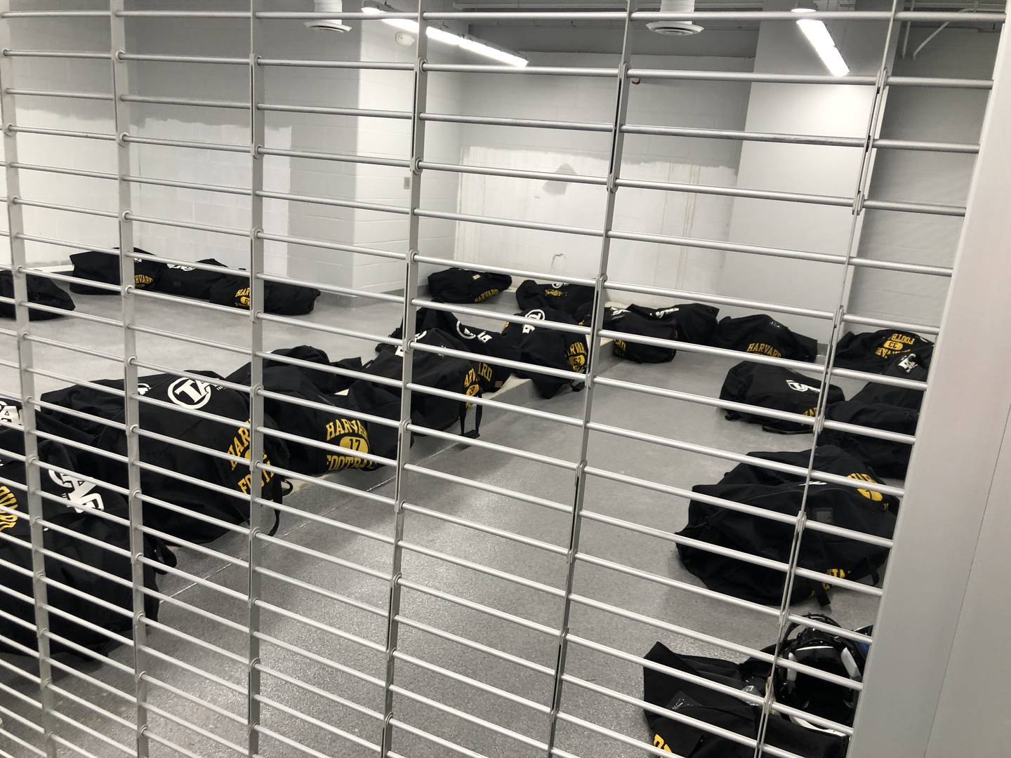 Football equipment sits waiting in duffel bags inside the new locker room's secure area on Aug. 9, 2022. The new lockers are expected in early September, after a seven-month delay.