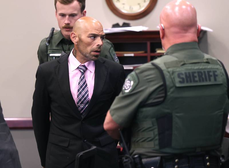 Nathan P. Sweeney talks to members of his family as he is cuffed by an Ogle County sheriff’s deputy Tuesday, Aug. 26, 2025, after his sentencing at the DeKalb County Courthouse in Sycamore. Sweeney received the maximum 14 years for driving under the influence and causing the 2024 crash that killed DeKalb County sheriff’s deputy Christina Musil.
