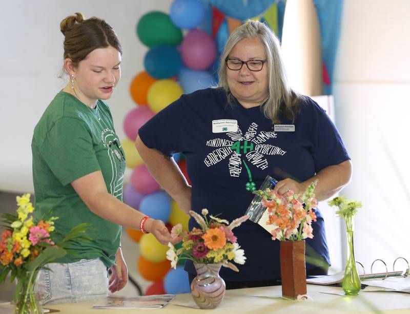 Myka McCoy of Princeton, has her flower bouquet judged by Bettyann Harrison during the Bureau County 4-H Fair on Thursday, July 13, 2023 in Princeton.