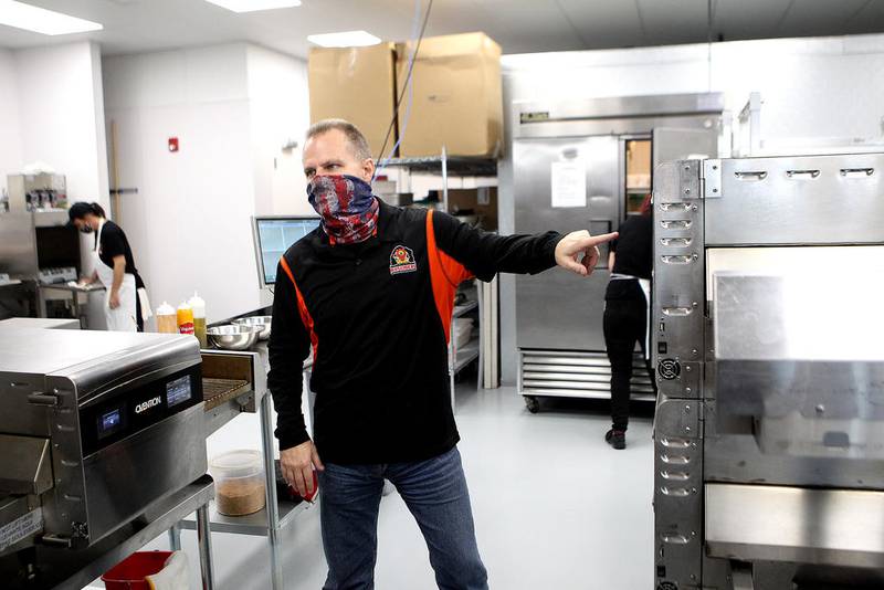 Lance Bell, owner of AJ Sliders in St. Charles, shows some of the kitchen equipment they use to make the sliders. The restaurant is now open for carryout and delivery at 2075  Prairie St., Suite 110, in St. Charles.