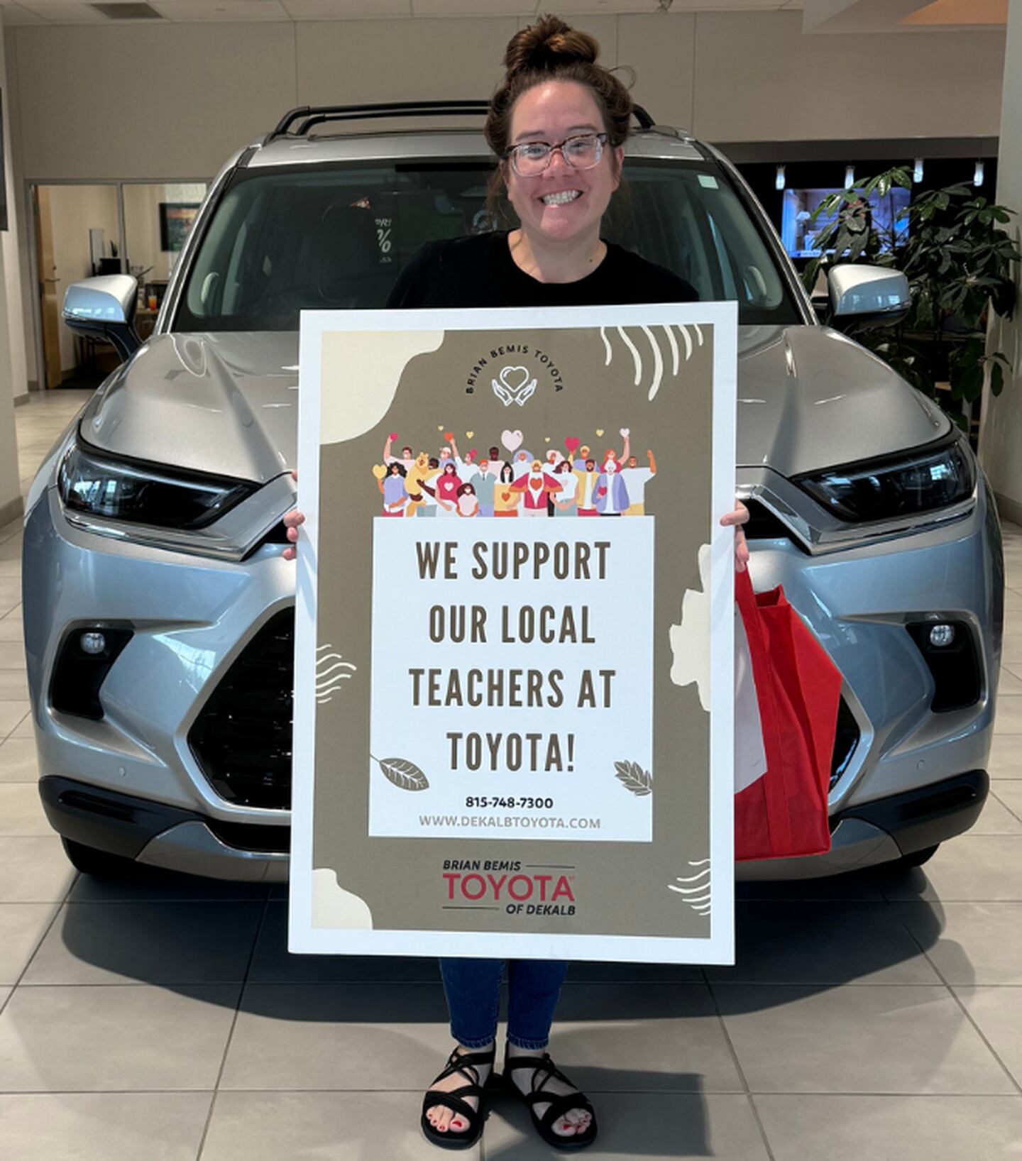 DeKalb school teacher receiving Brian Bemis Toyota of DeKalb school supplies donation