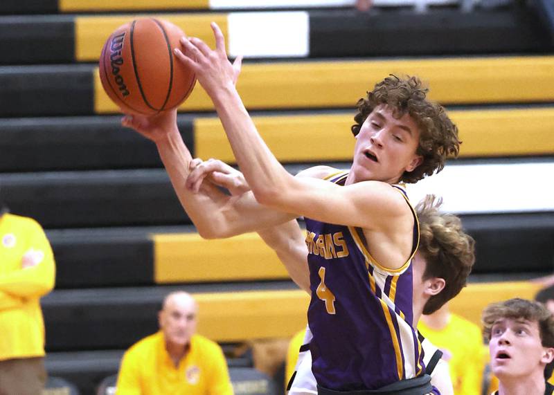 Mendota's Jace Baird grabs a rebound in front of Sycamore's Henry Bumpus during their game Wednesday, Dec. 13, 2023, at Sycamore High School.