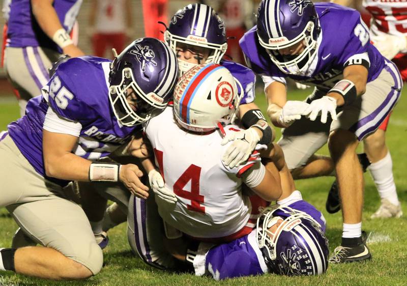 Rochelle defenders including Brode Metzger gang tackle an Ottawa player during Friday's game in Rochelle.