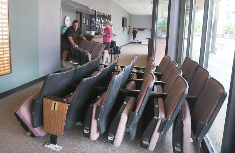 Will Daugherty removes Stage 212 seats  to the lobby with Natalie Smigel on Tuesday, Aug. 12, 2025 in La Salle. A church in Kalamazoo Mich. will be picking up the seats this weekend.