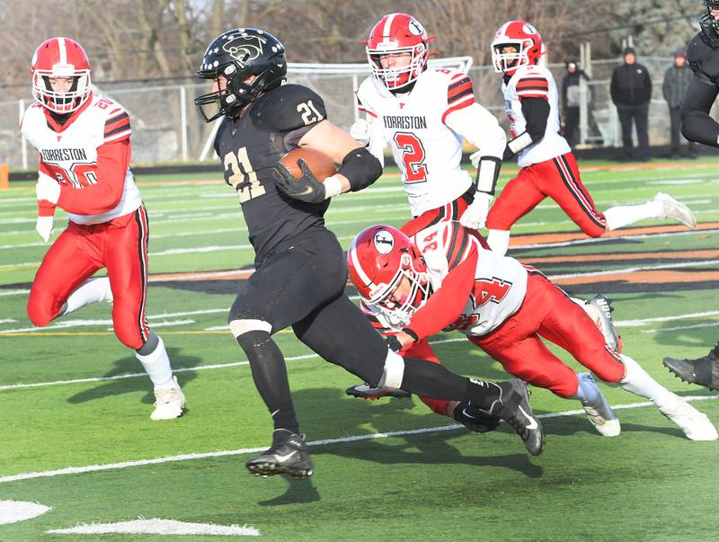 Lena-Winslow's Jake Zeal escapes Forreston's Jace Engbert as he runs for a bog gain at the 1A semifinal against Forreston at Freeport High School on Saturday, Nov. 19. The Panthers ended the Cardinals season willing the game 38-16 to advance to the state championship game next Friday in Champaign.