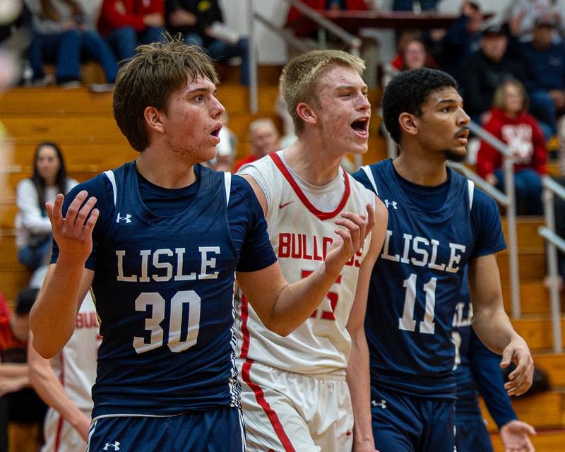 Lisle's Noah Nigro (30) reacts in confusion after Officials call as Streator Joseph Hoekstra (25) reacts in celebration on Wednesday, Feb. 18, 2026 at Streator High School in Streator.