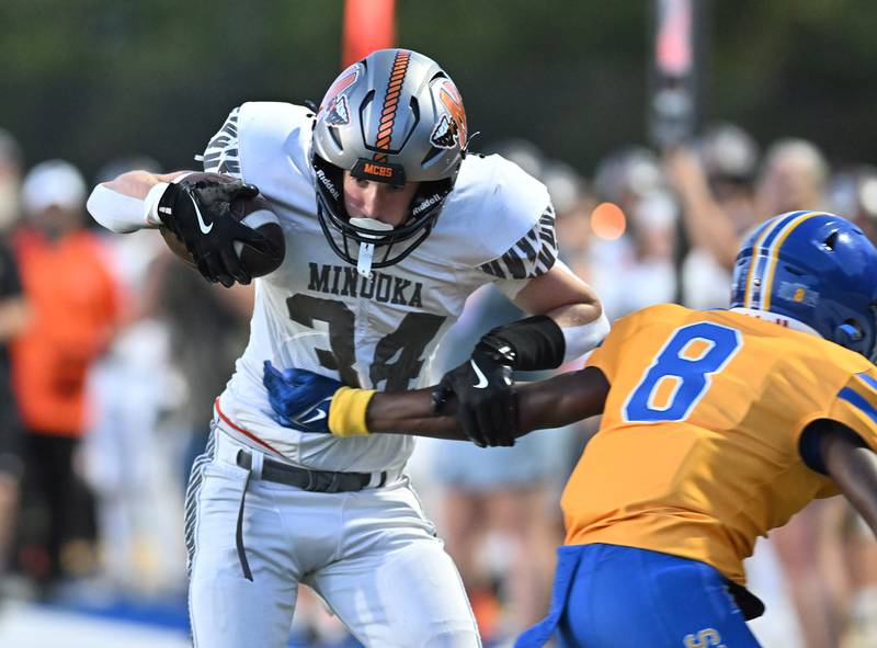 Minooka's Jaden Boe eludes Joliet Central's Javion Davis during a non-conference game on Friday, Sep 13, 2024 at Joliet. (Dean Reid for Shaw Local News Network)