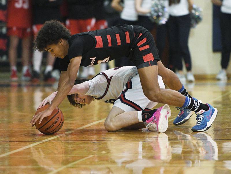 Saint Viator’s Ryan Jackson and Benet Academy’s Brayden Fagbemi battle for the ball in a boys basketball game in Arlington Heights on Tuesday, January 17, 2023.