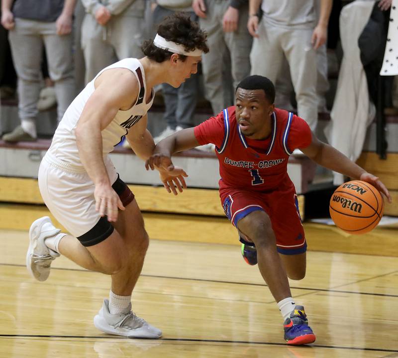 Dundee-Crown's Kadin Malone (right) tries to drive the baseline against Prairie Ridge's Luke Vanderwiel during a Fox Valley Conference boys basketball game on Friday, Jan. 16, 2026, at Prairie Ridge High School in Crystal Lake.