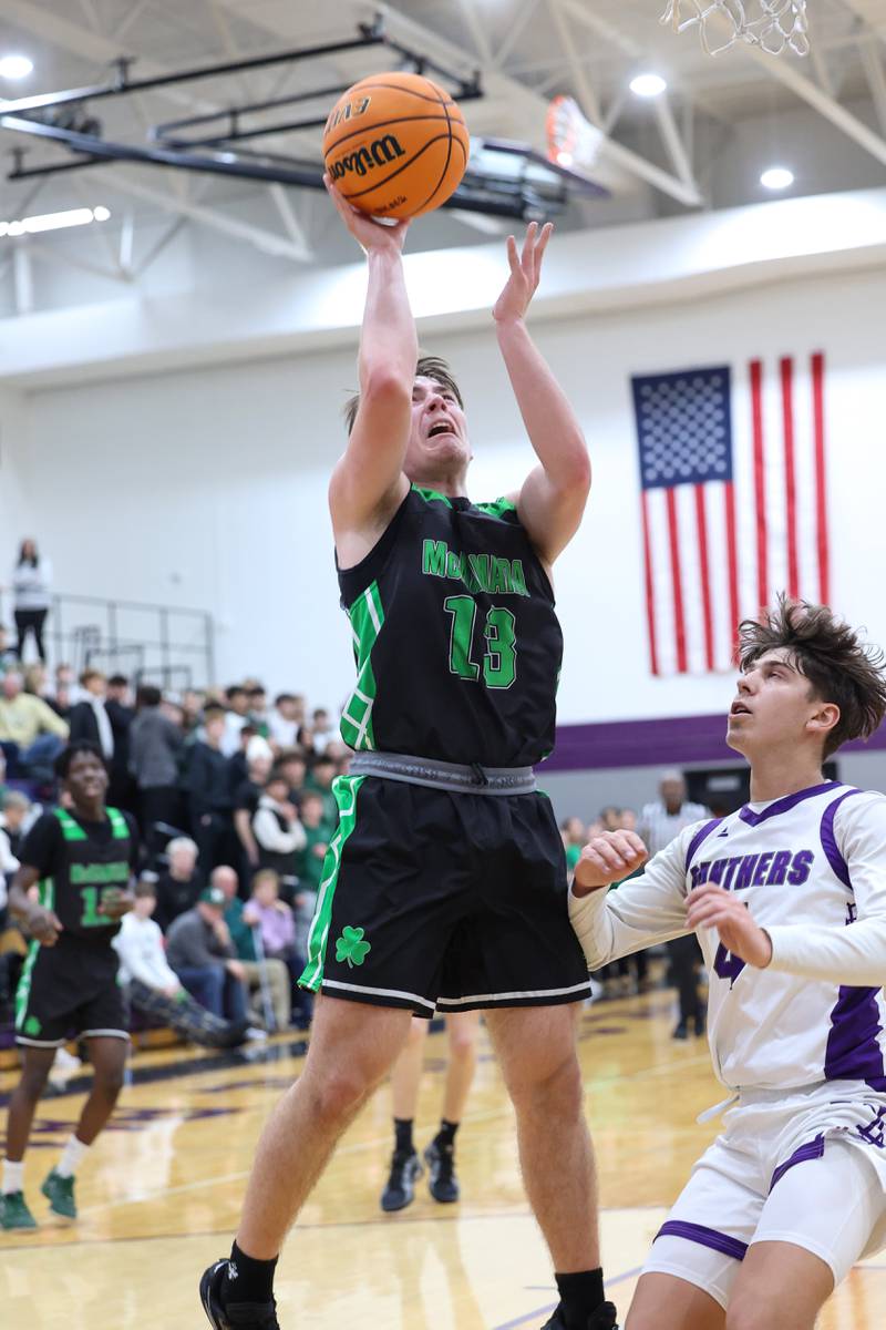 Bishop McNamara's Teddy Fogel hits a layup past Manteno's Cade Bechard during the Fightin' Irish's 61-24 victory over Manteno on Tuesday, Jan. 13, 2026.