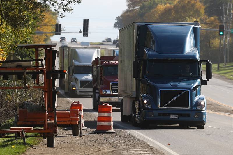 Trucks travel along South Chicago Street on Tuesday, Oct. 24 in Joliet.