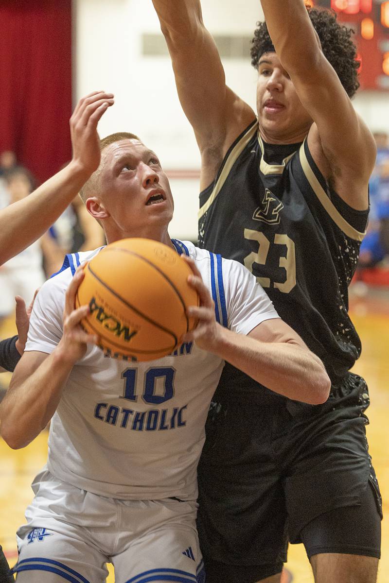 Newman’s George Jungerman works below the basket against Pecatonica’s Zion Braimah Tuesday, March 3, 2026, in the 1A sectional semifinal.