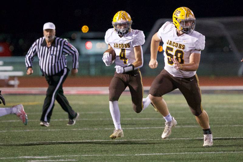 Jacob's Joey Scrivani carries the ball for a gain against Huntley on Friday, Sept. 23,2022 in Huntley.