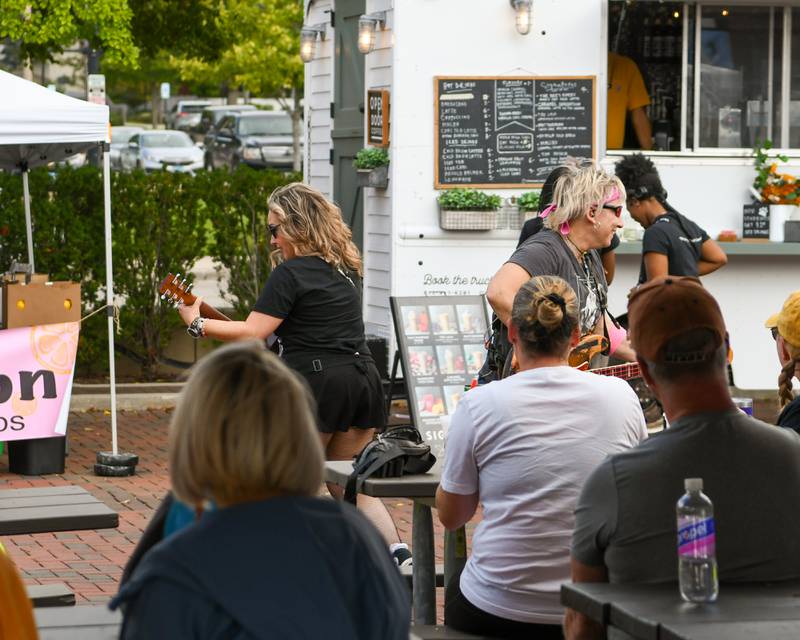 Members of The Prissillas band work the crowd during the Taste of DeKalb on Sunday, Sept. 29, 2024, held in downtown DeKalb.