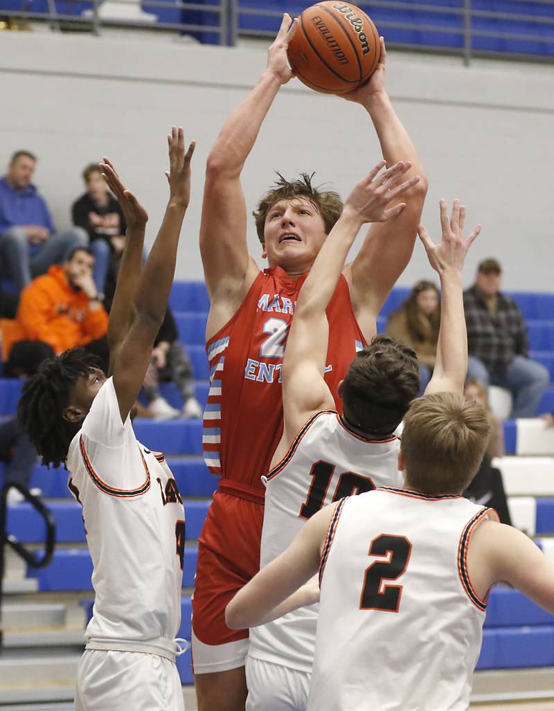 Marian Central's Christian Bentancur shoots the ball over DeKalb's Johnny Henderson and Eric Rosenau during a Central High School’s Dr. Martin Luther King, Jr., Boys Basketball Tournament game Friday, Jan. 13, 2023, at Central High School in Burlington.