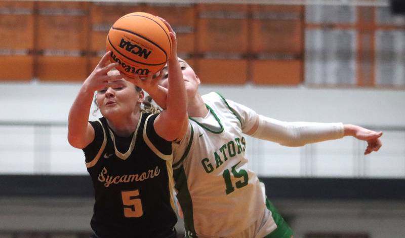 Crystal Lake South’s Tessa Melhuish, right, and Sycamore’s Grace Amptmann reach for the ball in girls IHSA Class 3A Sectional basketball on Tuesday, Feb. 24, 2026, at Crystal Lake Central High School in Crystal Lake.