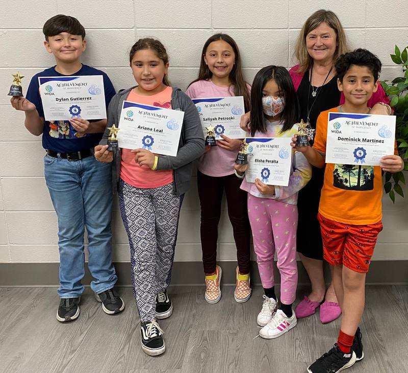 Troy Shorewood Elementary School students graduated from the school’s ELL program. Here, with their teacher Arlene Roderick.