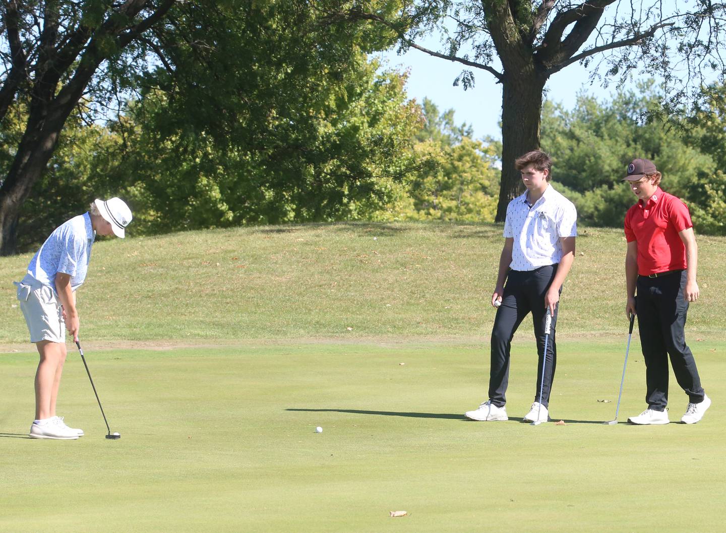 Burlington Central's Tyler Samaan, Kaneland's Brayden Seaton and Ottawa's Bryer Harris putt on the 10th hole during the Class 2A Regional golf meet on Wednesday, Oct. 2, 2024 at Senica's Oak Ridge Golf Club in La Salle.