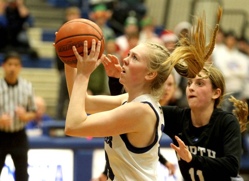Geneva’s Lauren Slagle shoots the ball during a home game against St. Charles North on Friday, Dec. 9, 2022.