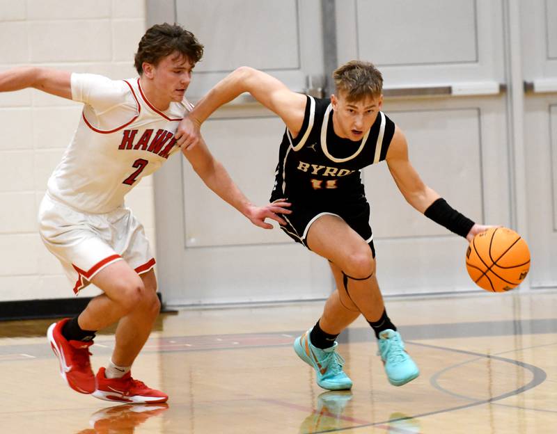 Byron's Cason Newton (11) dribbles up court as Oregon's Cooper Johnson (2) chases him on Monday, Dec. 15, 2025 at the 64th Forreston Holiday Tournament at Forreston High School.
