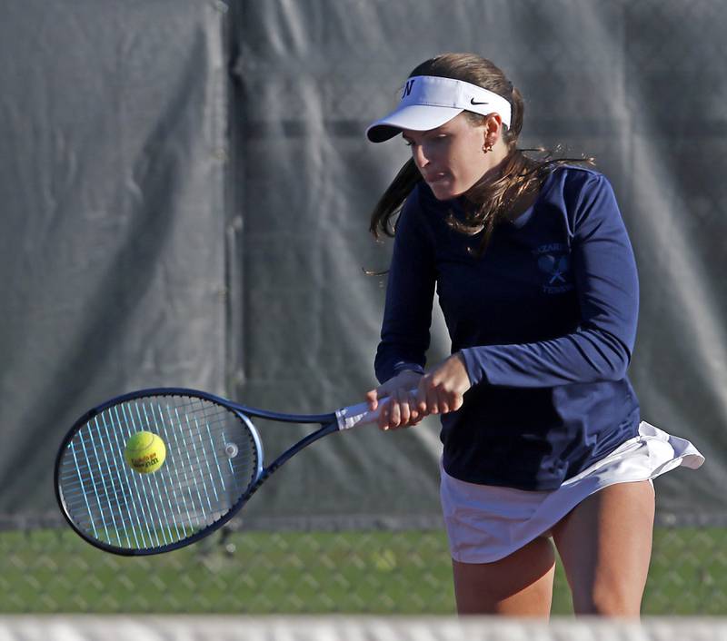 Nazareth Academy's Elaine McNamara returns the ball Thursday, Oct. 23, 2025, during the first day of the IHSA State Girls Tennis Tournament at Schaumburg High School.