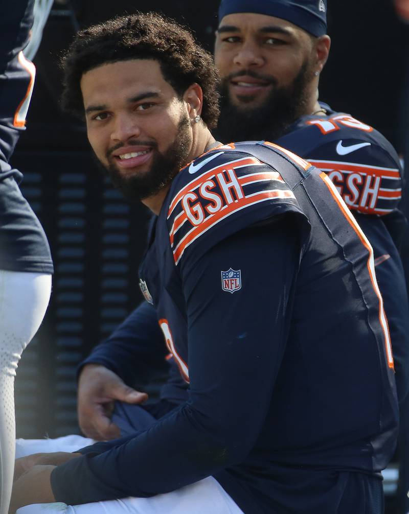 Chicago Bears quarterback Caleb Williams smiles with tight end Keenan Allen on the bench in the closing minutes after defeating the Carolina Panthers on Sunday, Oct. 6, 2024 at Soldier Field in Chicago.
