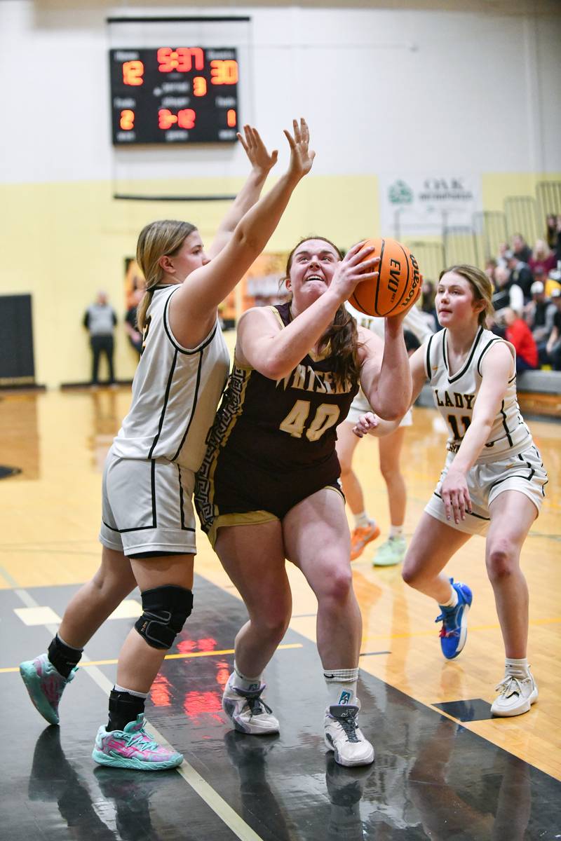 Watseka's Megan Martin shoots under pressure from Reed-Custer's Harlie Liebermann during the Warriors' 50-24 victory over Reed-Custer in the IHSA Class 2A Herscher sectional semifinal on Tuesday, Feb. 25.