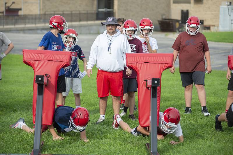 Morrison football coach Steve Snider runs his players through drills Tuesday, July 26, 2022 during camp.