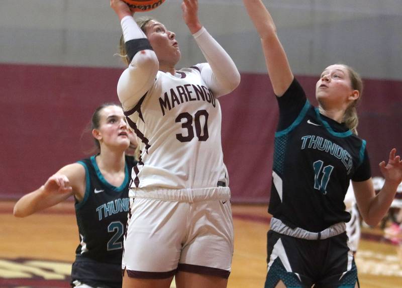 Marengo’s  Macy Noe works under the hoop against Woodstock North in varsity girls basketball on Tuesday, Dec. 2, 2025, at Marengo High School in Marengo.