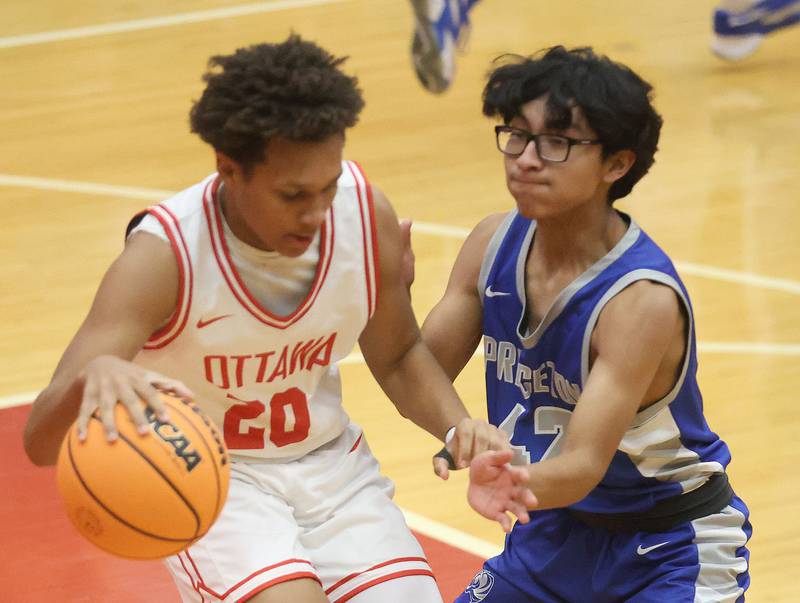 Ottawa's Kaden Konwinski dribbles outside of Princeton's Michel Sanchez-Rodriguez during the Dean Riley Shootin' The Rock Thanksgiving Tournament on Monday Nov. 24, 2025 in Kingman Gymnasium at Ottawa High School.