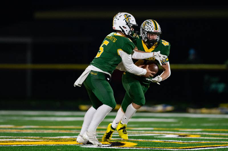 Coal City's Zander Meents hands the ball off to Landin Benson during the first round IHSA class 4A playoffs against Johnsburg on Friday Nov. 1, 2024 at Coal City High School