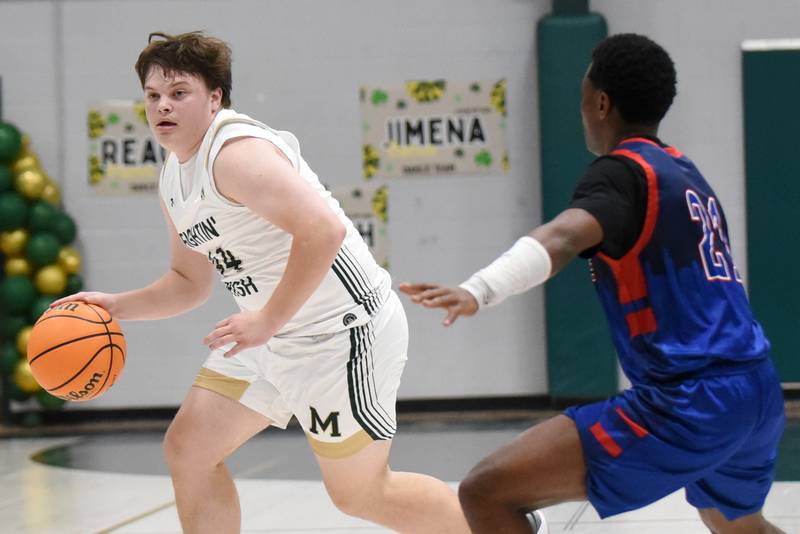 Bishop McNamara's Cale Hamilton, left, is guarded by Lycee Francais de Chicago's Jordie Machara during a game at Bishop McNamara Wednesday, Feb. 18, 2026.
