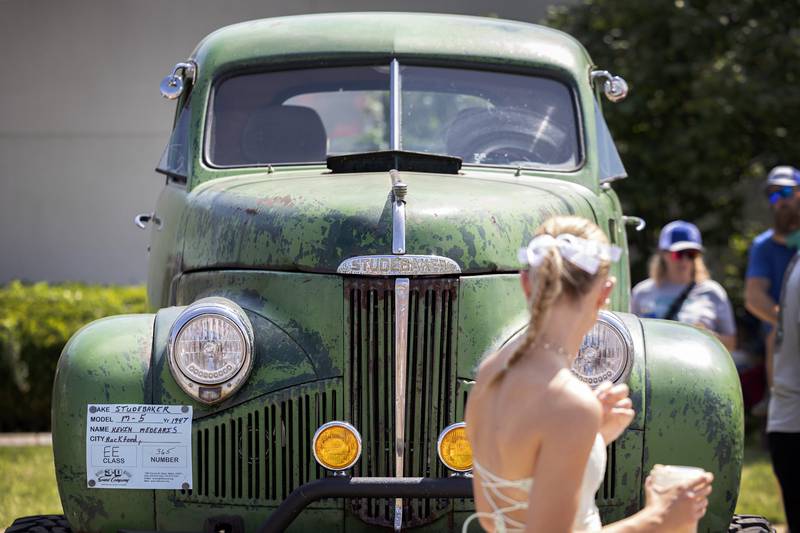 Visitors pass by a 1947 Studebaker truck on display in Amboy Sunday, August 27, 2023. The annual Depot Days car show brought in hundreds of vehicles and thousands of people who passed through the downtown.